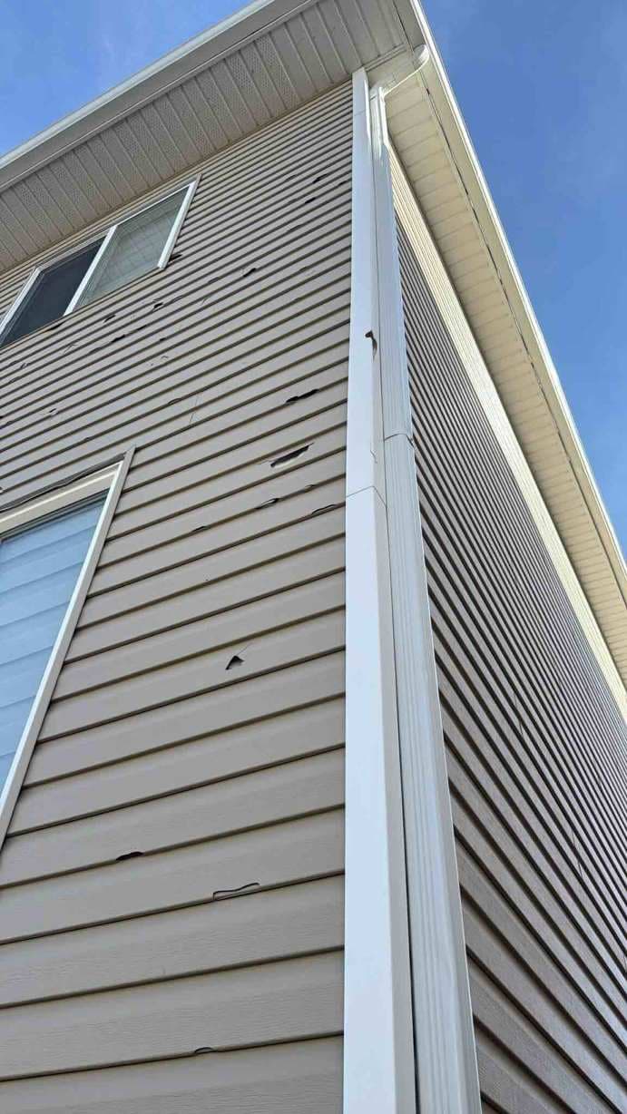 Professional hail damage assessment and repair in Calgary, showing our experts identifying and fixing storm damage